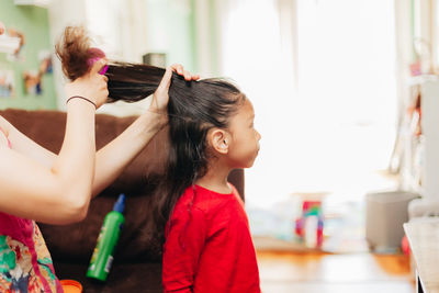 Girl holding women at home