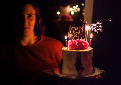 Midsection of woman with candles