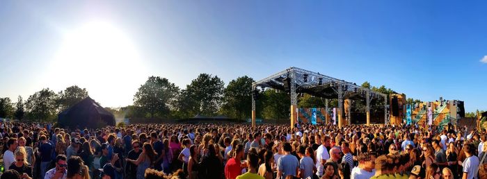 Panoramic view of crowd during festival against sky on sunny day