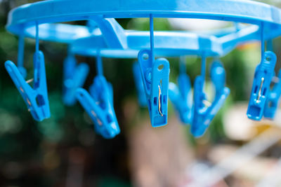 Close-up of clothespins hanging on clothesline