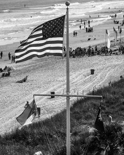 Scenic view of flag on field against sky