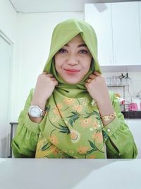 Portrait of smiling woman at home