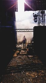 People standing on bridge against sky