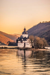 Scenic view of lake against sky during sunset