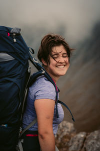 Portrait of smiling woman with arms raised