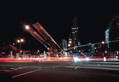 Light trails on road by vauxhall bus station at night