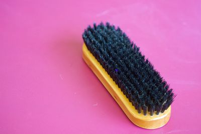 High angle view of brush on pink table