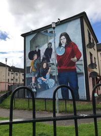 Portrait of young man and woman against building