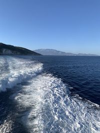 Scenic view of sea against clear blue sky