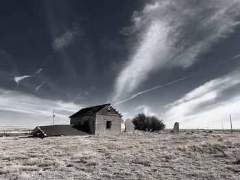 Houses on field against sky