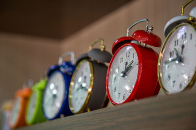 Low angle view of alarm clocks on table