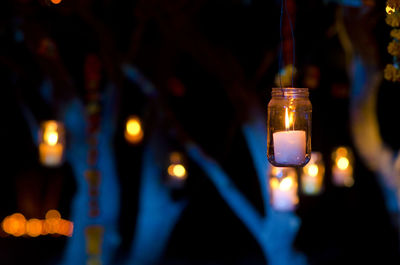 Close-up of illuminated tea light candles in temple