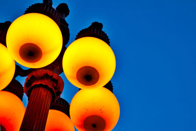 Low angle view of balloons against blue sky