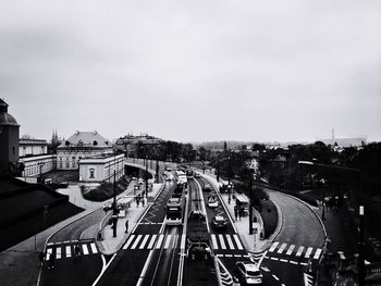 High angle view of cars on road in city against sky