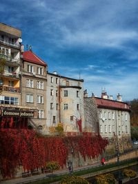 Low angle view of buildings in town against sky