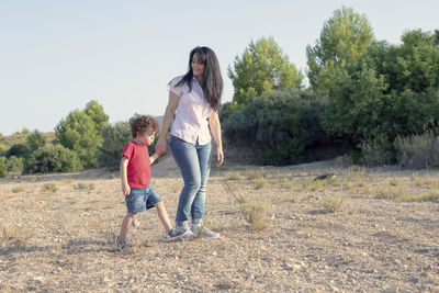 Woman with her son walking and enjoying the countryside far from the city