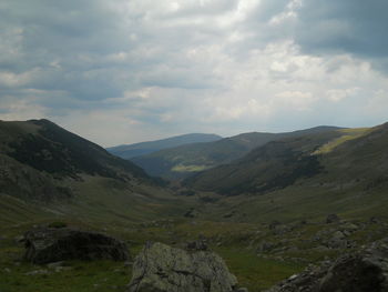 Scenic view of mountains against cloudy sky