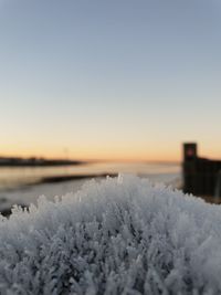 Scenic view of frozen lake against clear sky during winter