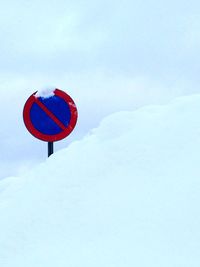 Road sign against sky