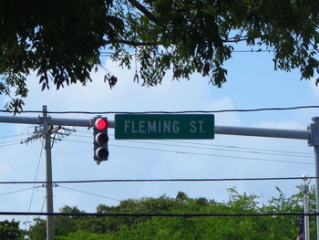 Low angle view of road sign against sky