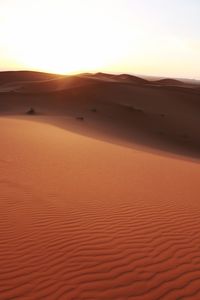 Scenic view of desert against sky during sunset