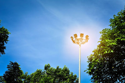 Low angle view of flood light against sky