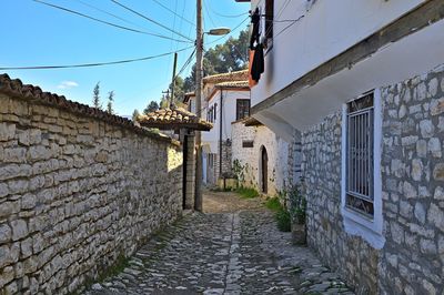 Narrow street amidst buildings against sky