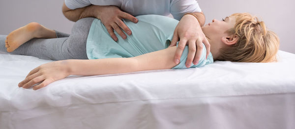 Young woman lying on bed at home