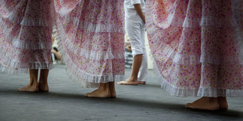 Low section of women standing on footpath