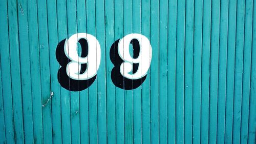 Number 99 on blue wooden wall