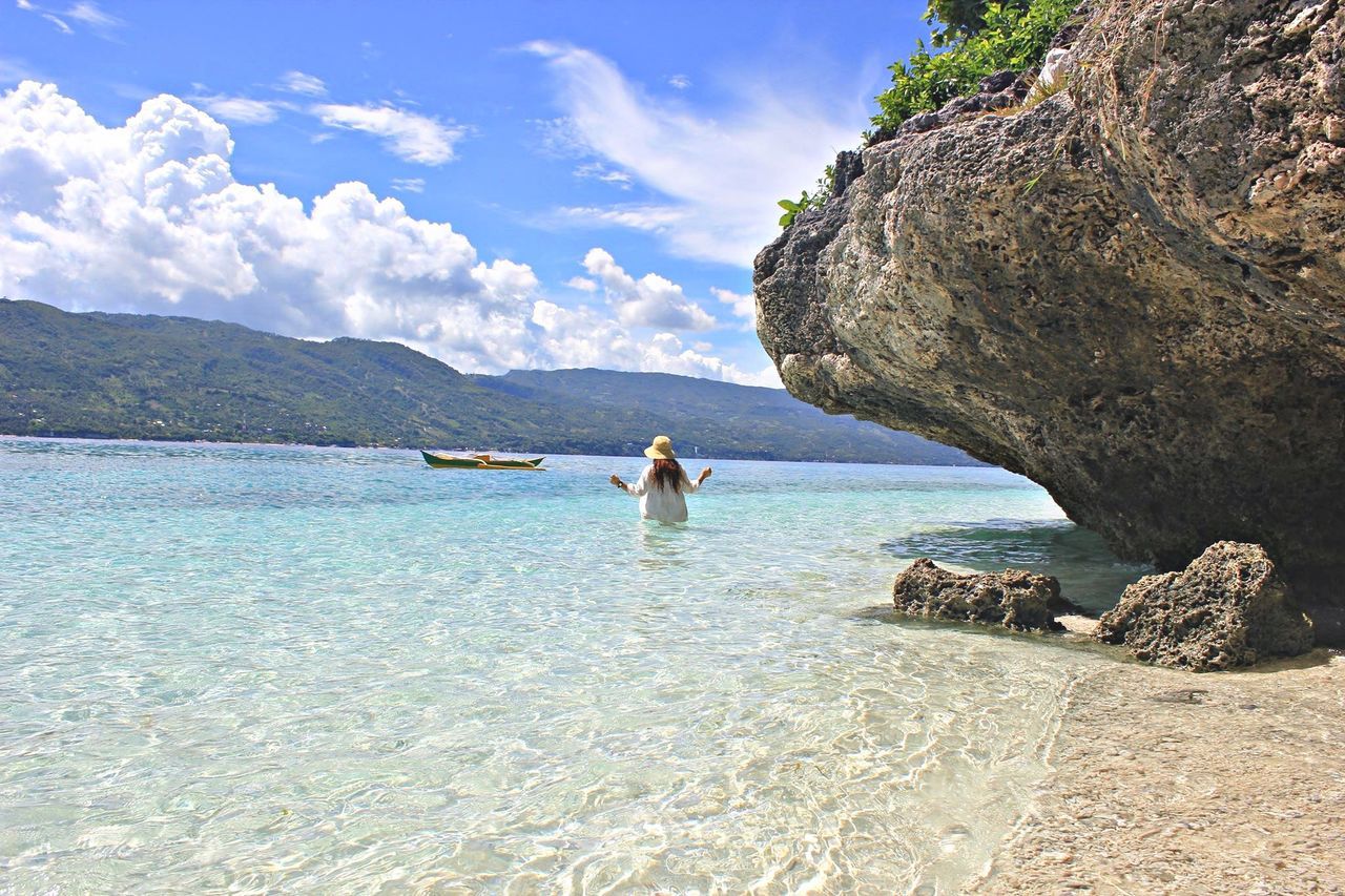 water, sky, sea, tranquility, tranquil scene, scenics, mountain, beauty in nature, nature, cloud - sky, cloud, shore, idyllic, blue, vacations, day, calm, mountain range, relaxation, remote, outdoors, non-urban scene, tourism, coastline, rippled, travel destinations, rock formation