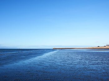 Scenic view of sea against clear blue sky