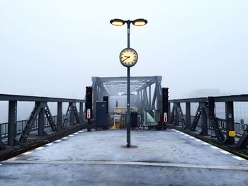 Railway bridge against sky in foggy weather