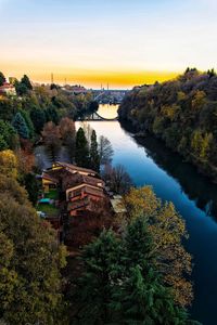 High angle view of river amidst trees against sky