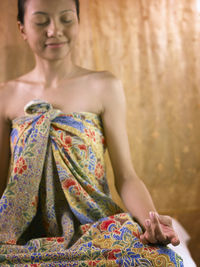 Young woman meditating in spa