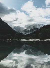 Scenic view of lake and mountains against sky