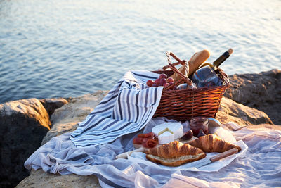 Close-up of food in basket by lake