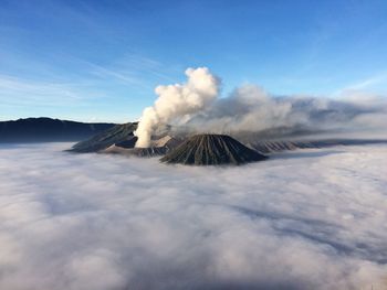 Scenic view of mt bromo amidst clouds against blue sky