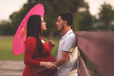 Side view of couple standing outdoors