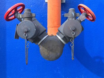 Close-up of coin-operated binoculars against blue wall