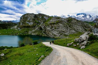 Road by mountain against sky