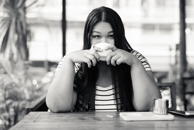 Portrait of woman sitting in restaurant