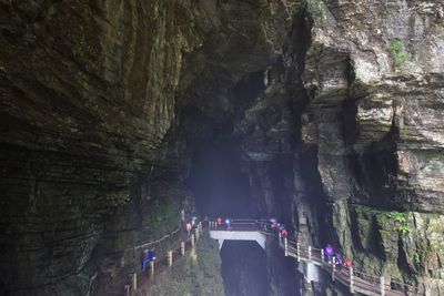 People on rock formation in cave