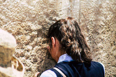 Rear view of woman on rock