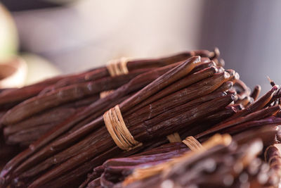 Full frame close up on bundles of vanilla beans on a market stall.