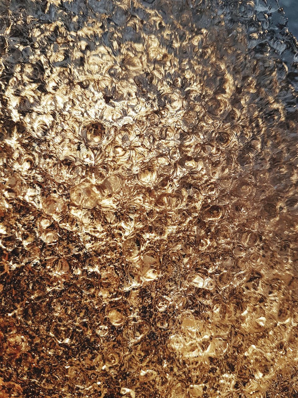 FULL FRAME SHOT OF WATER WITH BUBBLES IN BACKGROUND