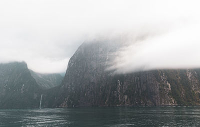 Scenic view of sea and mountains against sky