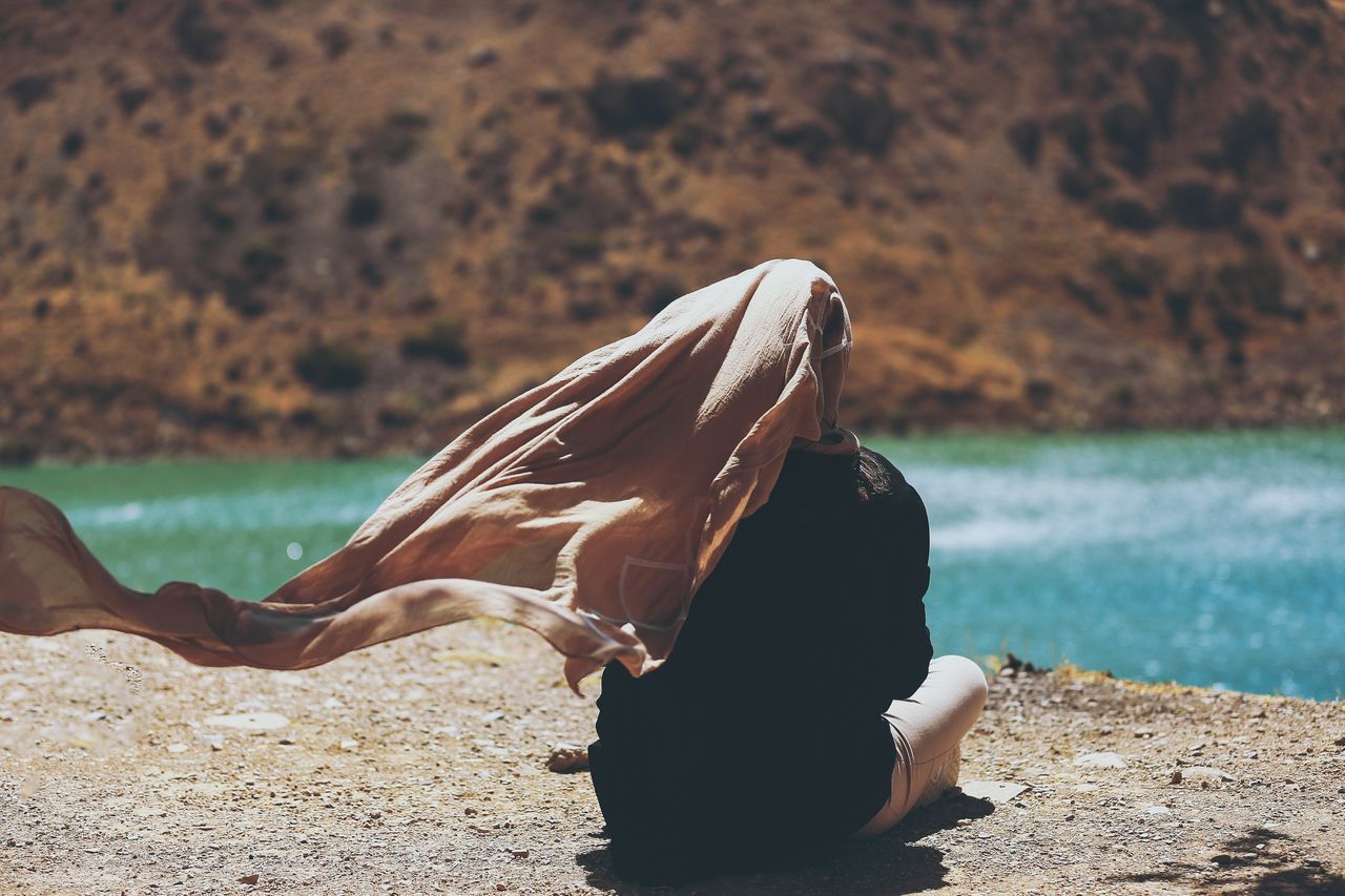 water, focus on foreground, young adult, nature, day, tranquility, sea, outdoors, shore, alone