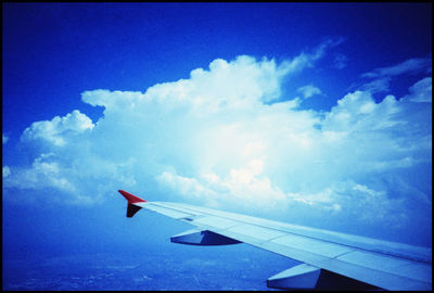 Airplane wing against sky