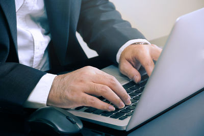 Midsection of man using mobile phone